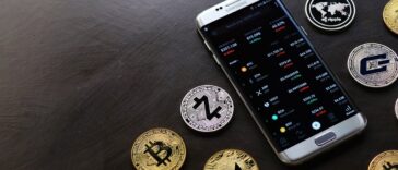 silver-gold-crypto-coin-iphone-on-table